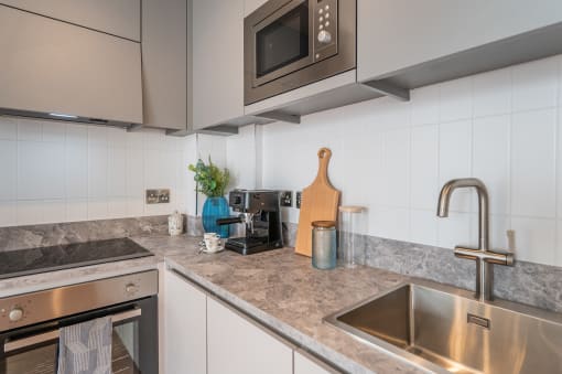 a kitchen with stainless steel appliances and marble counter tops