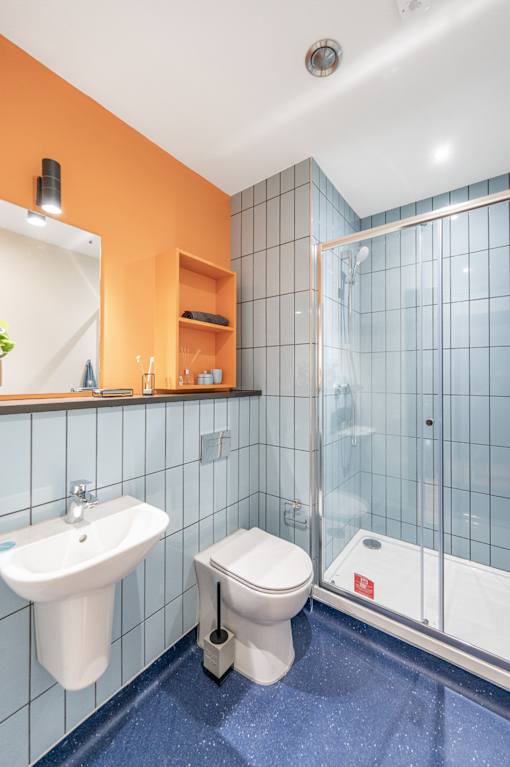 a bathroom with a toilet sink and shower
