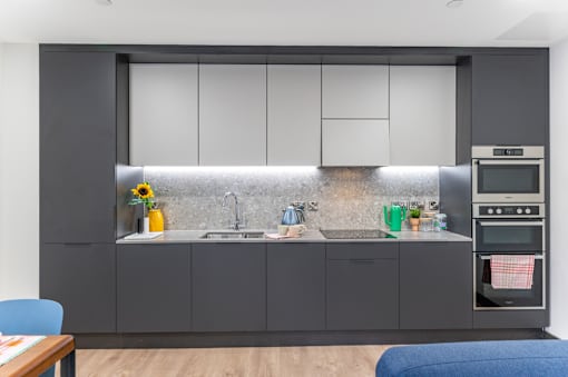 a kitchen with black and white cabinets and a sink