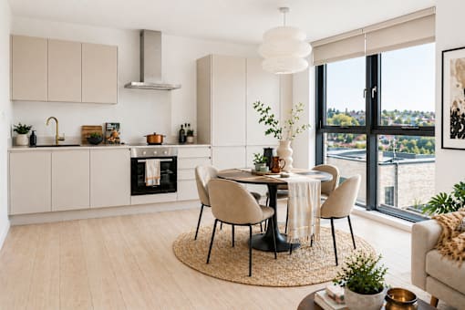 A modern kitchen with a dining table set for four.