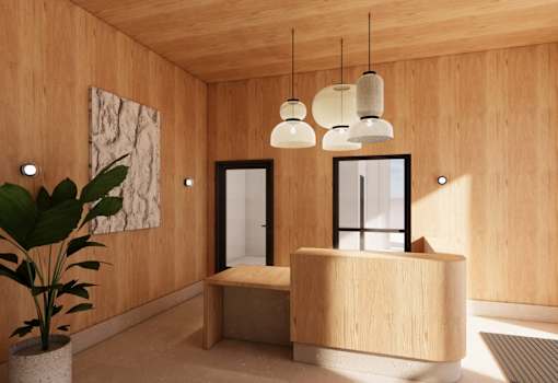 A wooden reception desk with a potted plant in front of it.