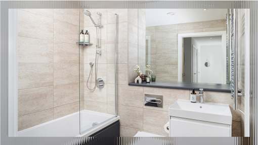A modern bathroom with a white sink and a glass shower stall.