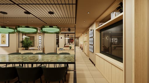 A restaurant with a long table and chairs under green lamps.