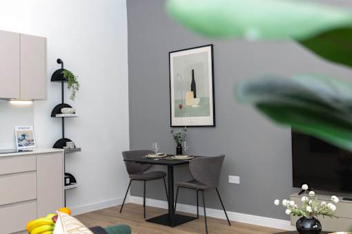 A dining area with a table and chairs.