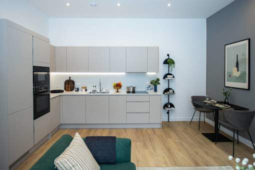 A modern kitchen with a dining table and chairs.