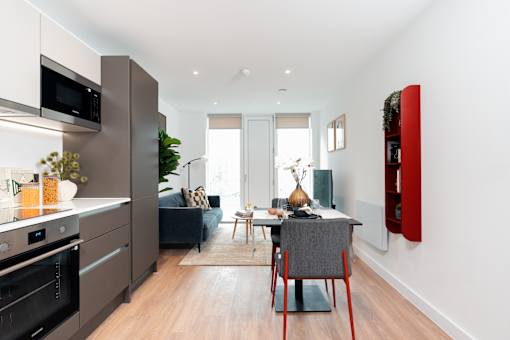 A modern kitchen with a dining table and chairs.