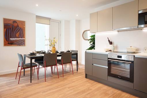 A modern kitchen with a dining table and chairs.