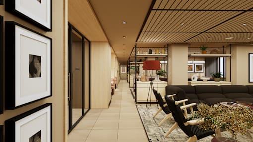 A long hallway with a black couch and a coffee table with flowers on it.