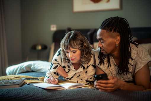 Couple reading a book together at Fairfax Apartments, Manchester