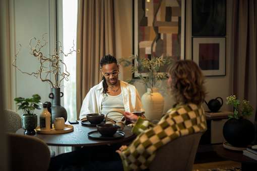 Couple sitting on dining table at Fairfax Apartments, Manchester, M1 2GN