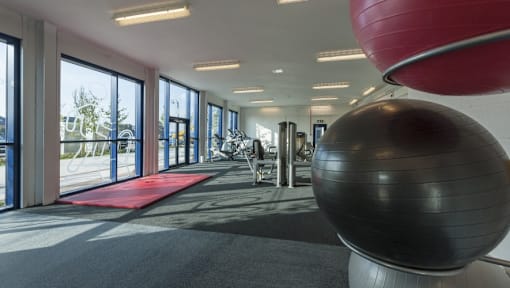 a gym with a yoga ball and exercise equipment in the lobby of a building at The Keel Apartments, Liverpool, L3 4GE