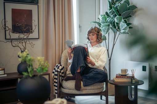 Women reading a book at Fairfax Apartments, Manchester, M1 2GN