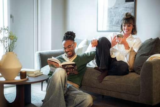 Couple sitting in living area at Fairfax Apartments, Manchester