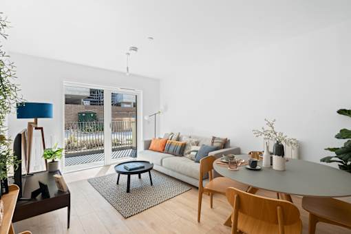 A modern living room with a glass door leading to a balcony.at The Quarters Apartments, Dock Road, ME4 4UB