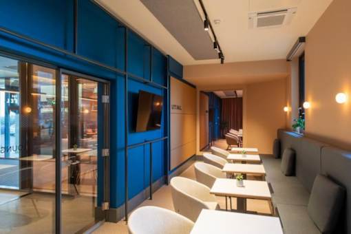 a restaurant with tables and chairs and blue walls at The Keel Apartments, Liverpool, L3 4GE