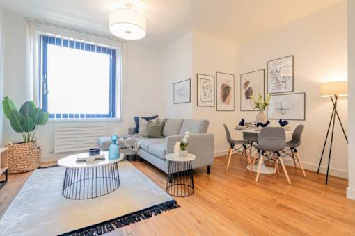 a living room with a couch and a dining room at The Keel Apartments, Liverpool