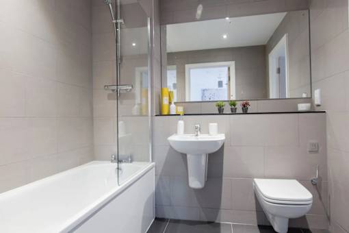 a bathroom with a sink toilet and a bath tub at Vox Apartments, Manchester
