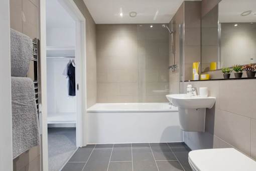 a bathroom with a sink and a bath tub at Vox Apartments, Manchester, M15 4YD