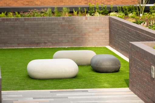 three stones on artificial grass in a garden at The Trilogy Apartments, Manchester