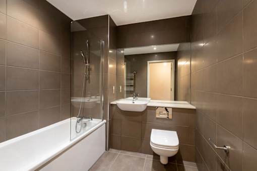 a bathroom with a sink toilet and a bath tub at The Trilogy Apartments, Manchester, M15 4RU