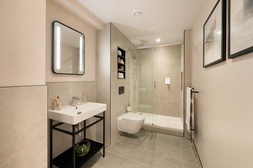 A bathroom with a sink, toilet, and shower.