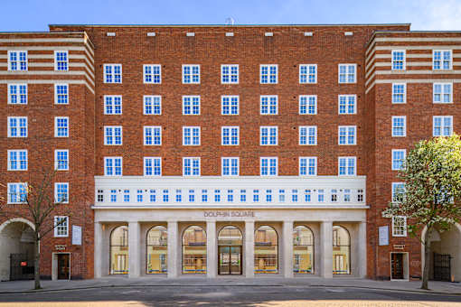 A large red brick building with the words "Dolphin Square" on the front.