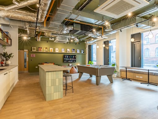 a game room with a pool table and a bar