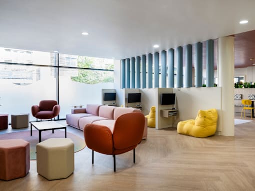 a living room with couches and chairs and a tv