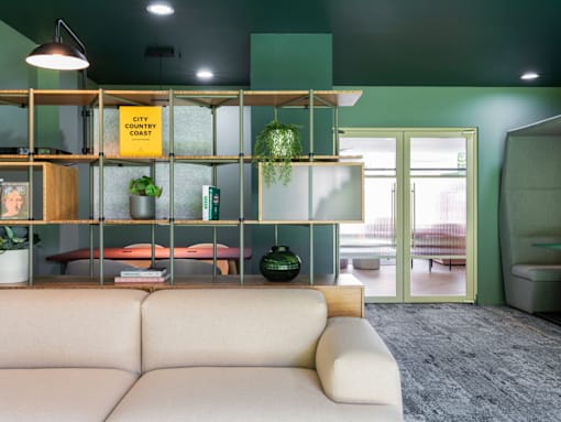 a living room with a couch and a shelving unit