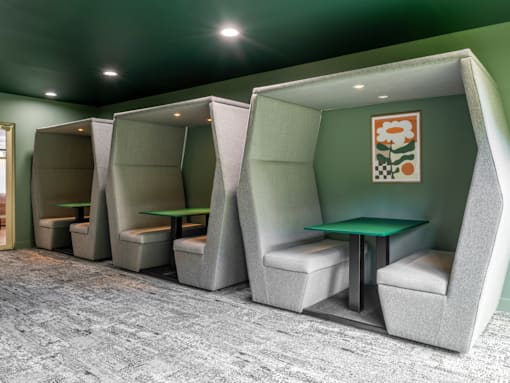 a group of booths with seats and a table in a room