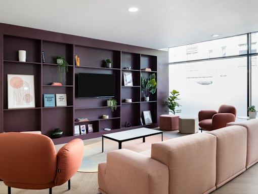 a living room with couches and chairs and a television