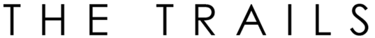 The image displays the words "THE TRAILS" in large, bold letters.