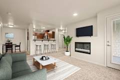 A modern living room with a fireplace and a flat screen TV.