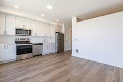 A kitchen with white cabinets and stainless steel appliances.
