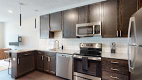 a kitchen with dark wood cabinets and stainless steel appliances