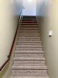 A carpeted staircase leading up to the living area, with a wooden handrail.
