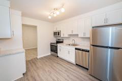 Renovated kitchen with stainless and black appliances. at Kings Gate West Apartments, Camillus, New York