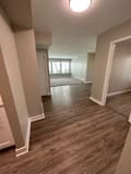 an empty living room with a hardwood floor