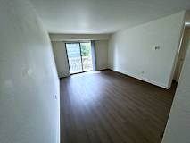 A living room with vinyl plank floors and white walls.