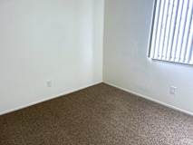Empty carpeted corner with electrical outlets and window at Huntington Place Apartments, Michigan, 48732