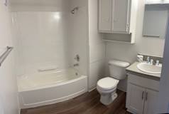A white toilet sits next to a sink in a bathroom