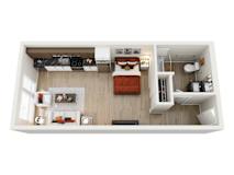 A top-down view of a neatly organized model  apartment home at ION Queen Anne with a bed, a couch, a kitchenette, and a workspace.