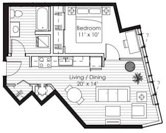 A floor plan of a room with a bedroom and living/dining area.
