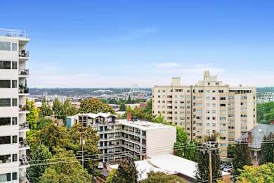 an aerial view of a city with tall buildings and trees