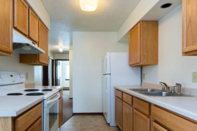 a kitchen with a stove refrigerator and sink