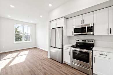 A kitchen with white cabinets and stainless steel appliances.
