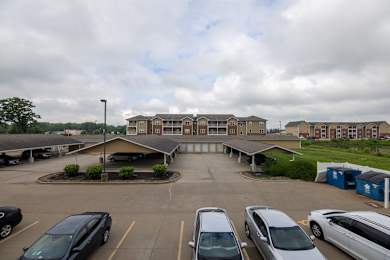 A parking lot with cars and a building in the background.
