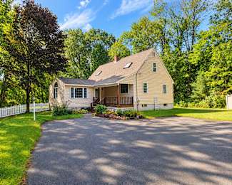 A house with a driveway in front of it.