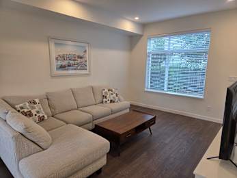 A living room with a large couch and a coffee table.