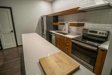 a kitchen with a counter and a stove and a refrigerator